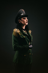 Portrait of a young woman in uniform, wearing latex gloves © Warpedgalerie