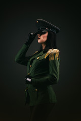 Portrait of a young woman in uniform, holding her cap by the hand