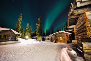 Beautiful Aurora Borealis in Lapland with very nice chalets. Luosto