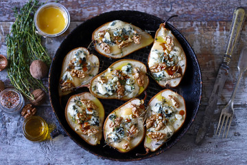 Baked pears with cheese and nuts. French cuisine Healthy food. Vegetarian lunch.