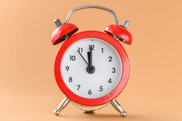 Red alarm clock on a light background