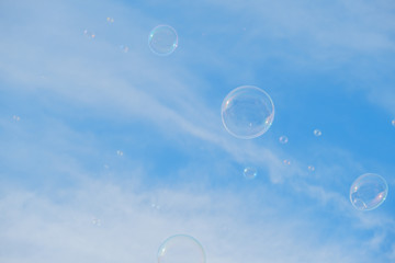 Soap bubbles on blue sky background