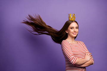 Portrait of positive cheerful smart high school girl crossing her hands proud of her prom party win gold crown haircut fly throw wear white sweater isolated over purple color background