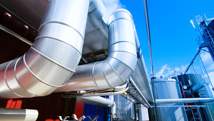 Industrial zone, Steel pipelines and valves against blue sky