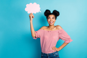 Photo of pretty dark skin lady hold empty paper cloud look up dreamy think over creative speech wear striped red white off-shoulders blouse jeans isolated blue color background