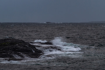 Small waves hitting black rocks from the tlantic ocean