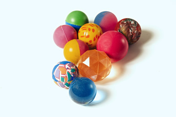 small colored rubber balls on a white background