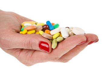 Pills in woman hand isolated on white background