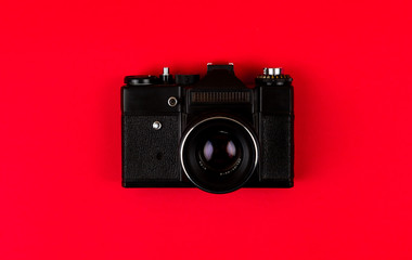 Flat lay film camera isolated on red background. Copy space