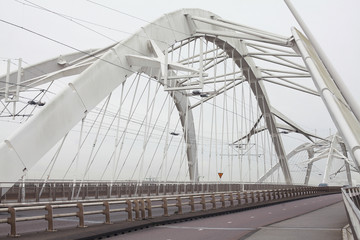 Amsterdam, Ijburg / Netherlands  - February 28 2020: Enneus Heermabrug Bridge connecting Ijburg with Amsterdam