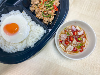 Rice topped with stir-fried pork and basil with fried egg and chilli and fish sauce