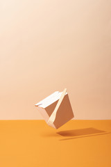 Fototapeta na wymiar Arranged Organic box with fork on orange background with shadow