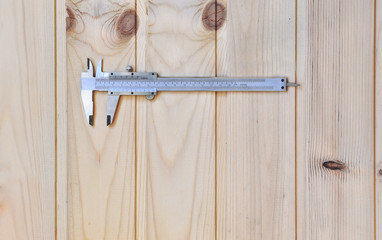 Measuring tool Vernier Calipers on a wooden workbench