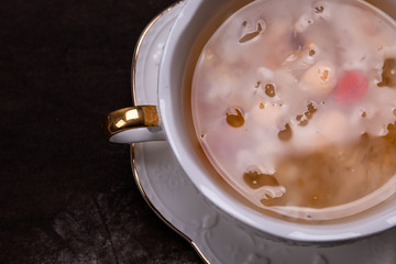Chinese sweet soup in a white cup with  a dark background