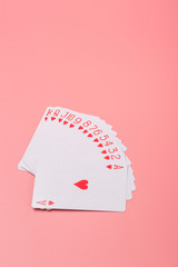 Expanded playing cards on pink background
