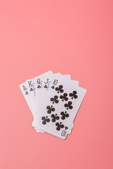 Expanded playing cards on pink background