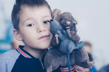 Boy's face with a toy mouse, close-up