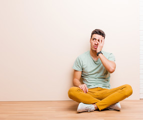 young arabian man feeling bored, frustrated and sleepy after a tiresome, dull and tedious task,...