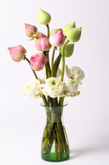Green white and pink lotus flower in glass green vase