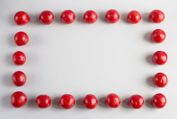 Red ripe tomatoes are laid out in rectangle on white background. Healthy lifestyle. Raw food diet.