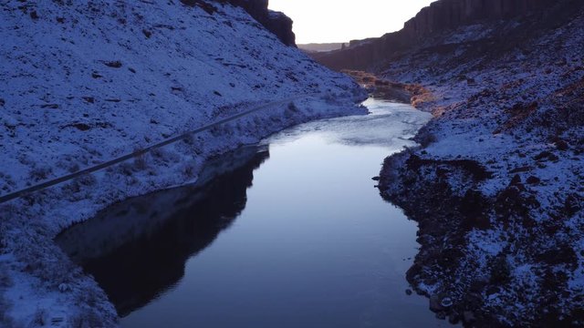 Aerial Footage of Colorado River in Wintertime Near Moab, Utah U.S.A. Following Cars Approaching Flyover Drone Footage