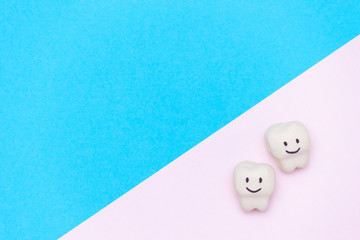 White smiled tooth, space for text on color background. Healthy dental teeth concept.