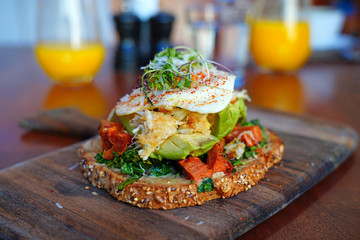 Multigrain avocado toast with fried egg on top
