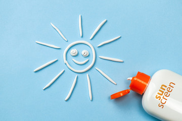 Sunscreen. Cream in the form of sun on blue background with white tube