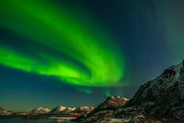 Fototapeta na wymiar amazing polar lights, Aurora borealis over the mountains in the North of Europe - Lofoten islands, Norway
