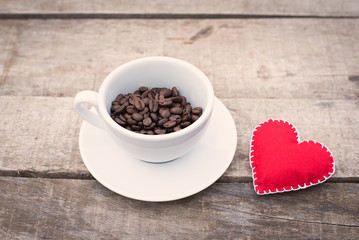 Cup of coffee beans on a wooden table