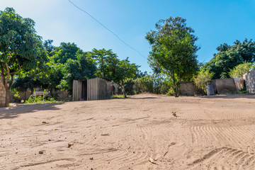 Sandy road in African neighborhood in Maputo, Mozambique