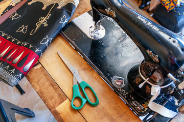 Sewing machine and African fabrics in seamstress workshop, Mozambique
