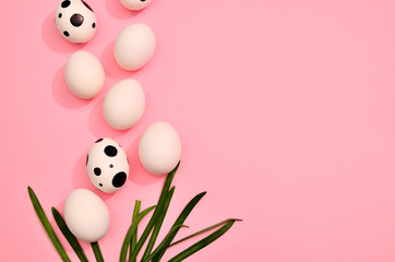 White easter hand drawn eggs with green myrtle leaves pattern on trend pink pastel color...