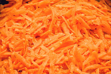 Closeup macro photo of thickly grated or shredded carrot to cook or eat fresh
