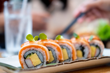 Close up and selective focus of salmon sushi roll maki © Dontree