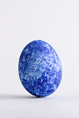 one Easter classic blue egg on white background