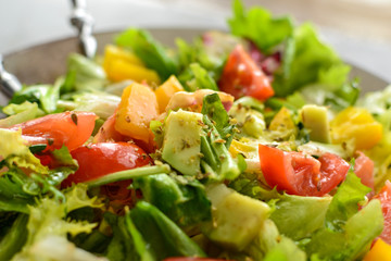 Healthy vegan food. Useful vegetable salad dressing, tomatoes, bell peppers, avocado. Close-up. Vegetarianism and veganism.