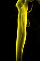 Obraz premium Yellow smoke on black background