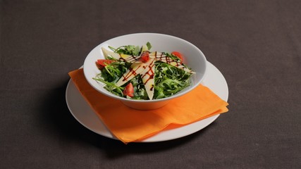 Arugula and Parmesan salad with cherry tomatoes.           
