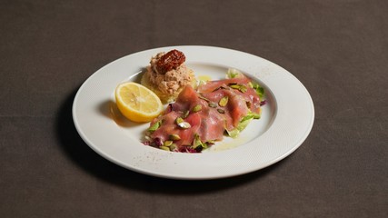 Tartar of fish with pumpkin seeds, with fish paste with sun-dried tomato and lemon.       