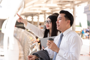 usinesswoman Pointing By Businessman While Standing On Bridge