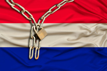 iron chain and castle on the silk national flag of the Netherlands with beautiful folds, the...