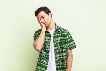 young handsome man feeling bored, frustrated and sleepy after a tiresome, dull and tedious task,...