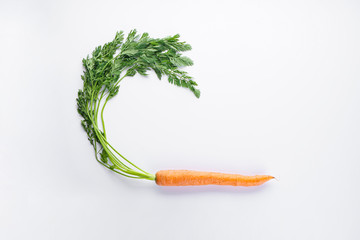 Flat lay composition of fresh carrot on a white background. Space for text