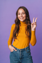 Image of young beautiful woman smiling and gesturing peace fingers