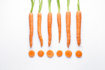 Flat lay composition with ripe fresh carrots on white background