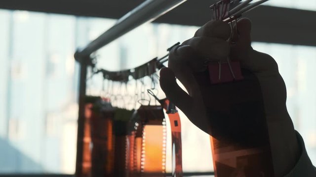 Close- up of a man hanging films to dry