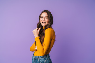 Image of young beautiful woman smiling and pointing finger at copyspace