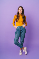 Full length image of beautiful woman with long hair smiling at camera
