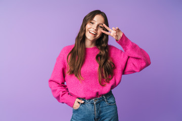 Image of young beautiful woman smiling and gesturing peace fingers